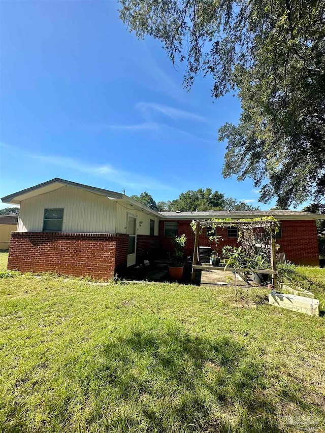 back of property featuring a yard