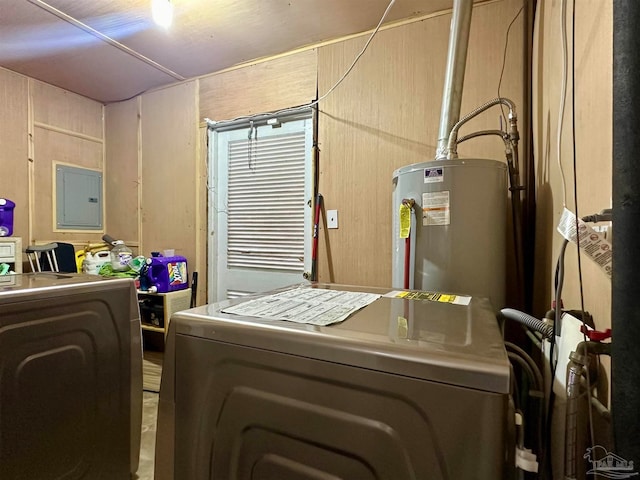 clothes washing area with water heater, wooden walls, electric panel, and independent washer and dryer