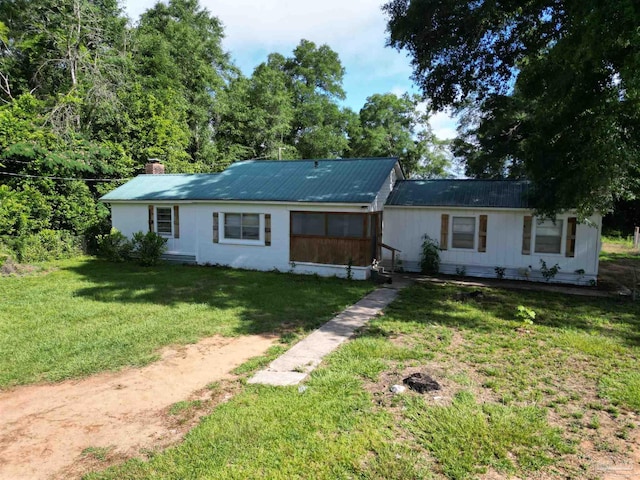 1159 Twin Bridges Rd, Flomaton, AL 36441 - ranch-style house featuring a front lawn, a chimney, and a metal roof