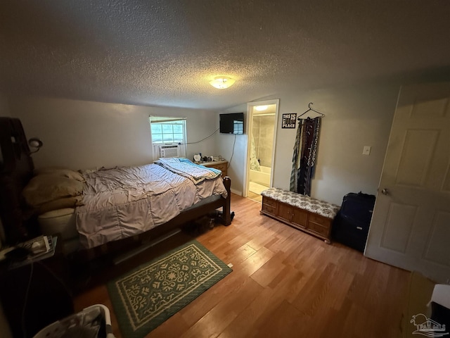 1159 Twin Bridges Rd, Flomaton, AL 36441 - bedroom with light wood-type flooring, cooling unit, and a textured ceiling