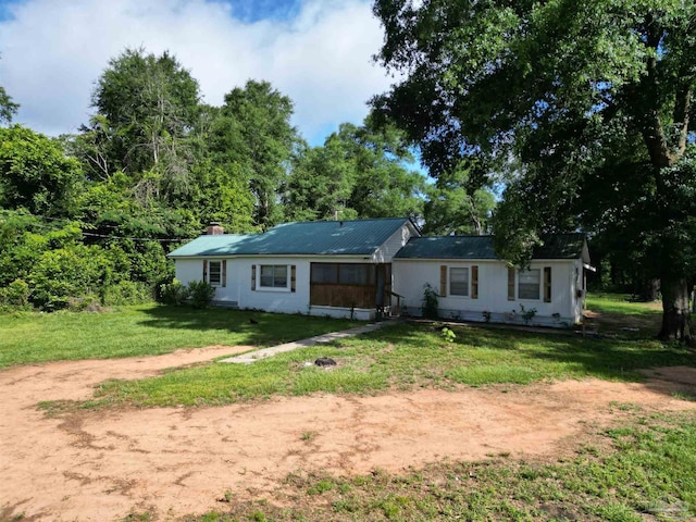1159 Twin Bridges Rd, Flomaton, AL 36441 - rear view of property with a lawn, dirt driveway, and a chimney