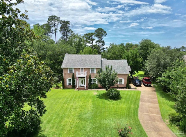 5013 Roland Rd, Pace, FL 32571 - colonial inspired home with concrete driveway, a front lawn, roof with shingles, and brick siding