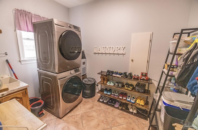 5013 Roland Rd, Pace, FL 32571 - laundry room with estacked washer and dryer and light tile patterned floors