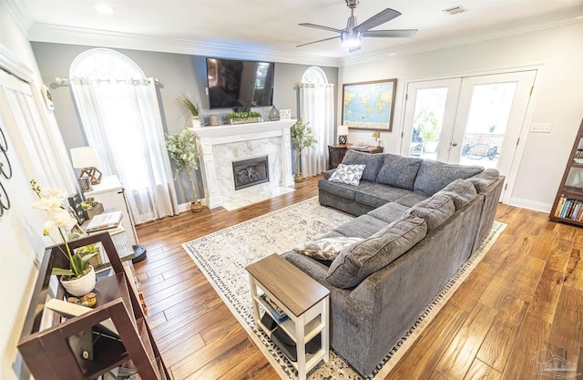 5013 Roland Rd, Pace, FL 32571 - living room with french doors, a ceiling fan, a fireplace, healthy amount of natural light, and ornamental molding