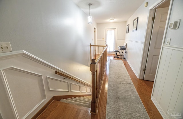 5013 Roland Rd, Pace, FL 32571 - corridor featuring wood finished floors, a decorative wall, a wainscoted wall, and an upstairs landing