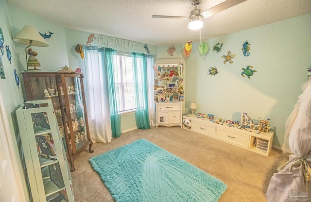 5013 Roland Rd, Pace, FL 32571 - rec room featuring a textured ceiling, a ceiling fan, and carpet flooring