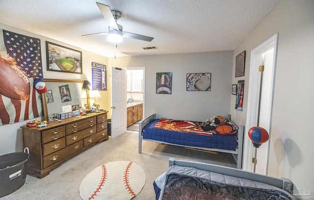 5013 Roland Rd, Pace, FL 32571 - bedroom with light colored carpet, a textured ceiling, ensuite bathroom, and a ceiling fan