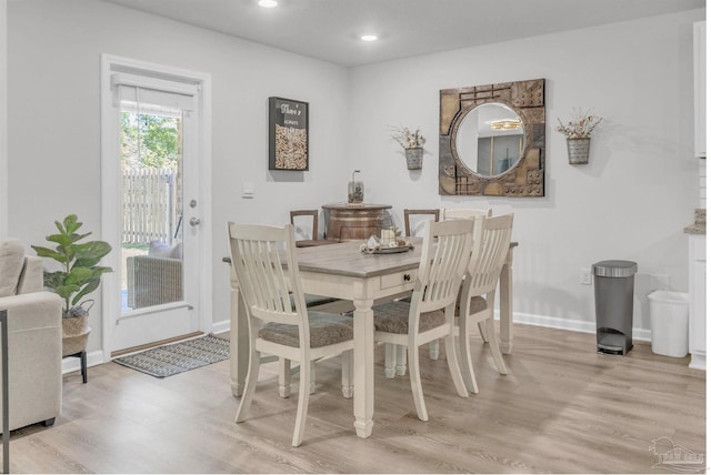dining space with light wood finished floors, baseboards, and recessed lighting