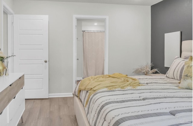 bedroom with baseboards, recessed lighting, and wood finished floors