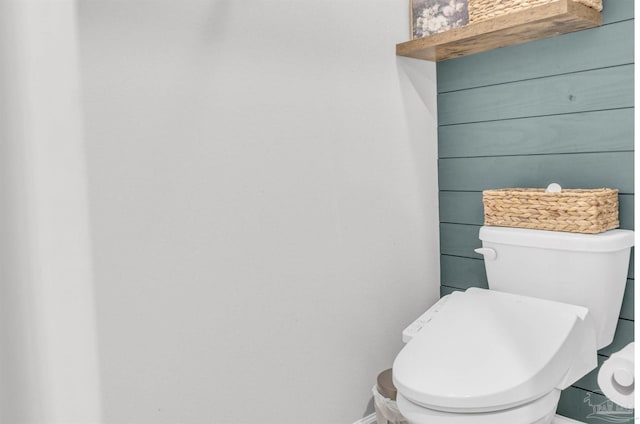 bathroom with toilet and baseboards