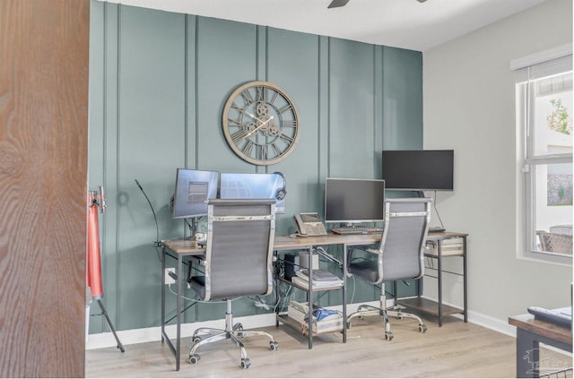 office space featuring ceiling fan, baseboards, and wood finished floors