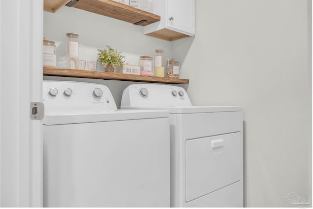 laundry room with cabinet space and washer and clothes dryer