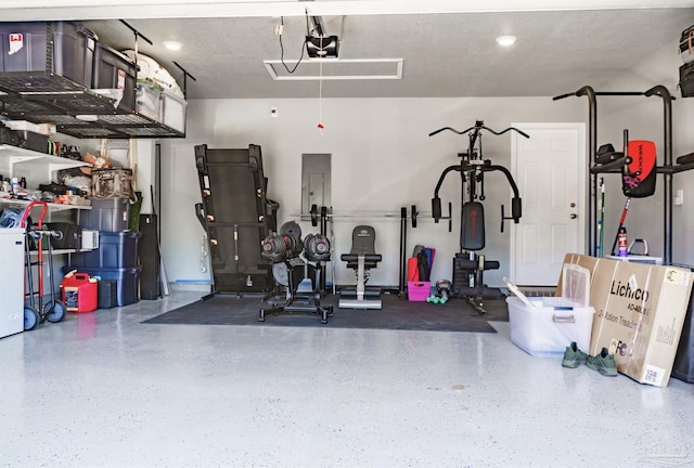garage with a garage door opener and electric panel