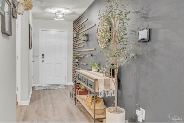 interior space featuring wood finished floors and baseboards