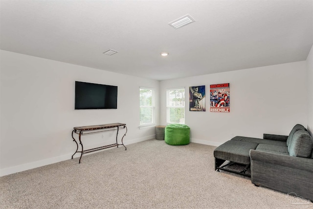 living area with recessed lighting, baseboards, visible vents, and light colored carpet