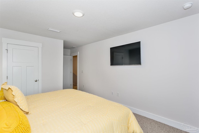 carpeted bedroom featuring visible vents and baseboards