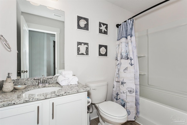 bathroom featuring toilet, shower / bath combo, vanity, and visible vents