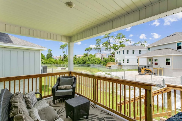 wooden deck featuring a fenced backyard, a residential view, and an outdoor living space