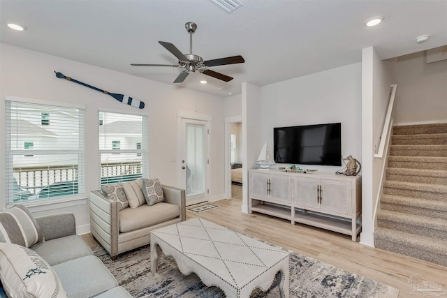 living area featuring light wood finished floors, recessed lighting, stairway, a ceiling fan, and baseboards