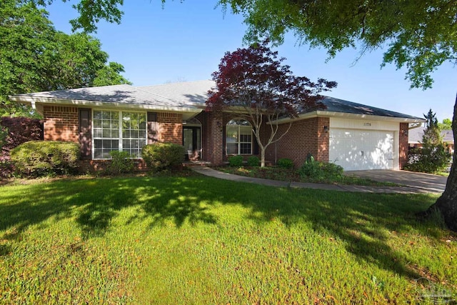 single story home with brick siding, a front lawn, an attached garage, and driveway