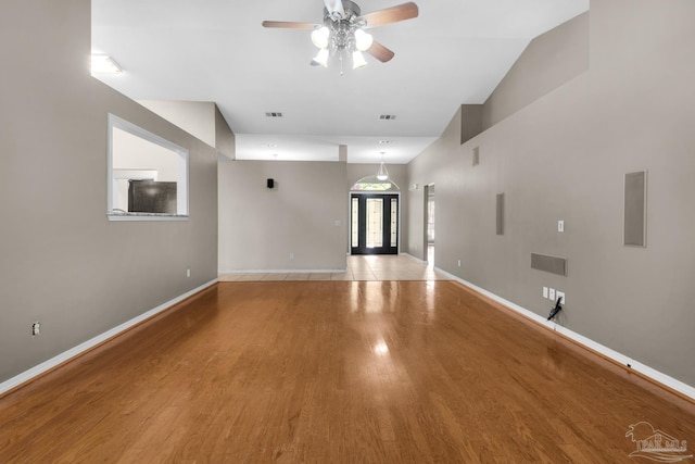 unfurnished living room featuring visible vents, ceiling fan, light wood finished floors, and baseboards