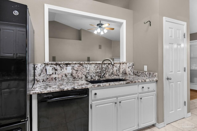 kitchen with light stone counters, a ceiling fan, black appliances, lofted ceiling, and a sink