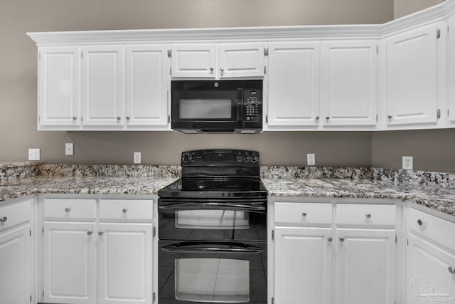 kitchen featuring white cabinetry, black appliances, and light stone countertops