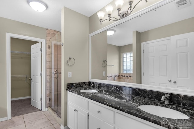 bathroom with a shower stall, visible vents, and a sink