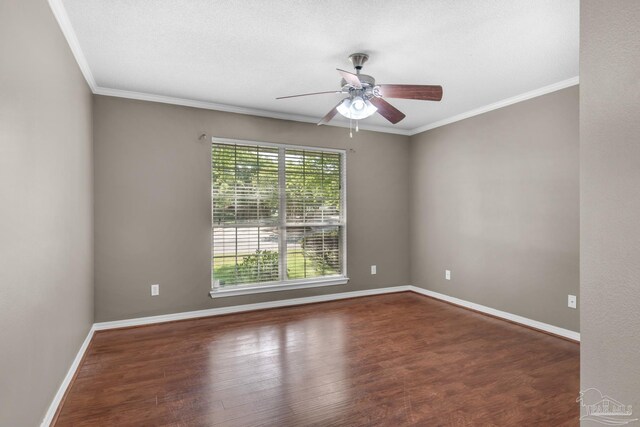 empty room featuring wood finished floors, baseboards, crown molding, and ceiling fan