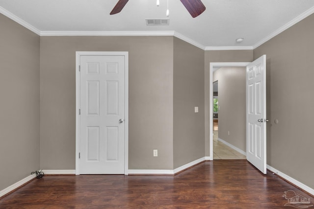 unfurnished bedroom featuring visible vents, baseboards, ornamental molding, and wood finished floors