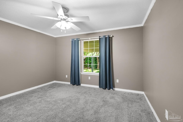 empty room with crown molding, ceiling fan, baseboards, and carpet floors