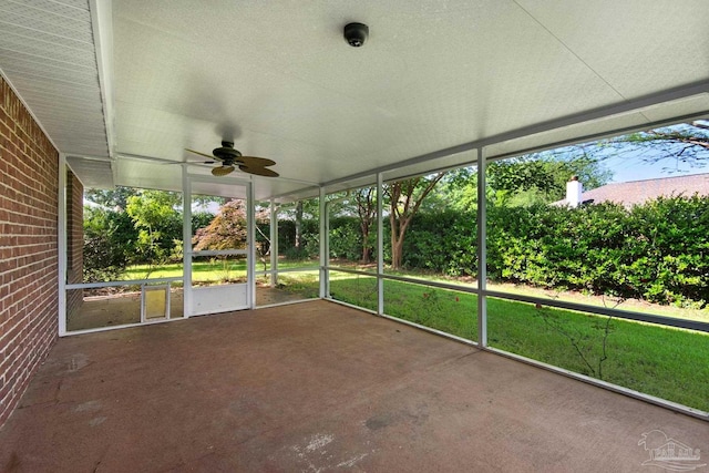 unfurnished sunroom with a ceiling fan