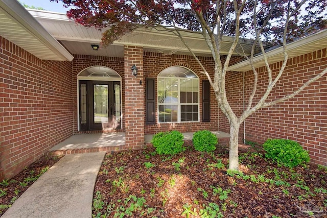 entrance to property featuring brick siding