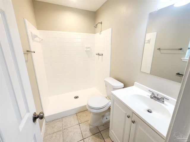 bathroom with toilet, walk in shower, vanity, and tile patterned floors