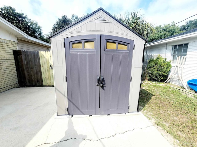 view of outbuilding featuring a lawn