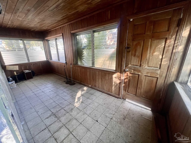 unfurnished sunroom with wood ceiling