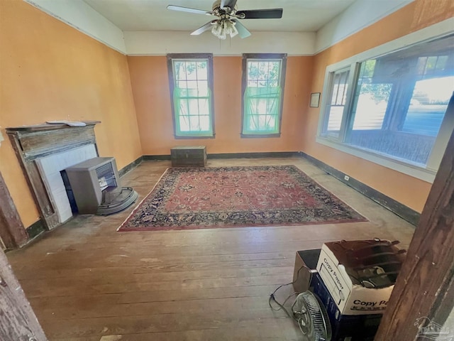 living room featuring hardwood / wood-style floors and ceiling fan