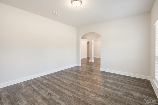 spare room featuring dark hardwood / wood-style flooring