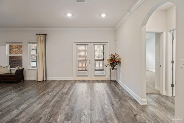 foyer featuring ornamental molding, dark hardwood / wood-style floors, and french doors