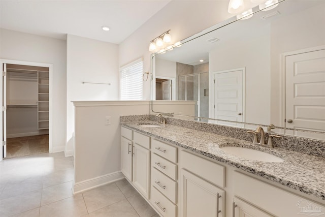 bathroom with vanity, tile patterned flooring, and a shower with door