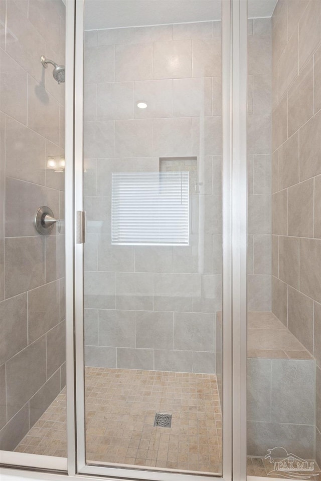 bathroom with a shower with shower door