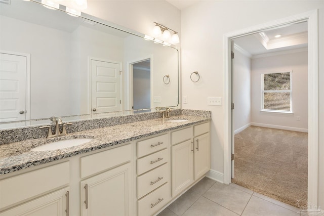 bathroom featuring tile patterned flooring, vanity, crown molding, and a raised ceiling