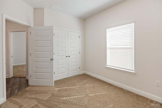 unfurnished bedroom with carpet flooring and a closet