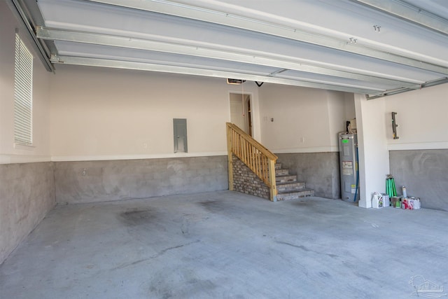 garage with a garage door opener, electric panel, and water heater