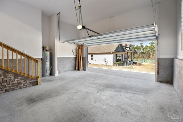 garage featuring a garage door opener and electric water heater