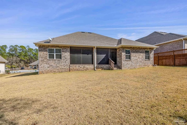 rear view of house with a yard