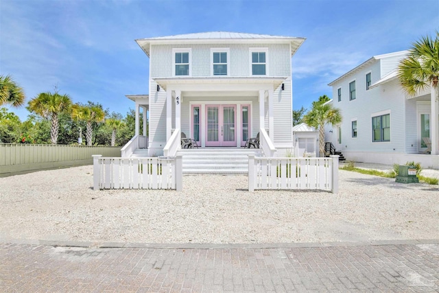 view of front of house with an outbuilding, fence, and french doors