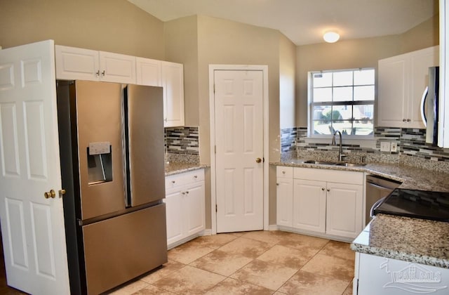 kitchen featuring light stone counters, white cabinetry, sink, and appliances with stainless steel finishes