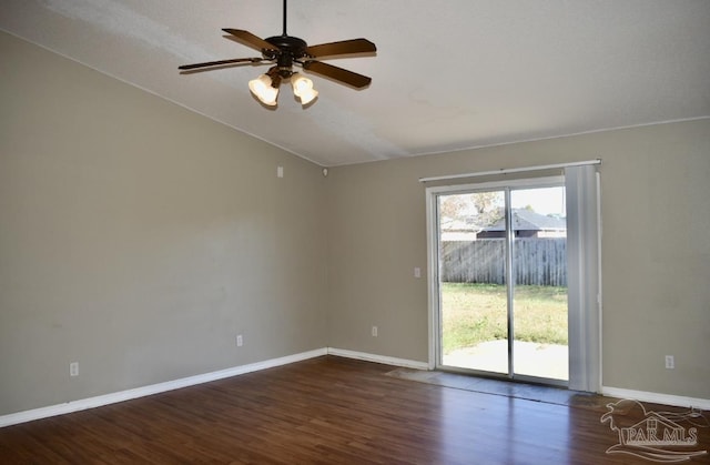 unfurnished room with dark hardwood / wood-style floors, vaulted ceiling, and ceiling fan