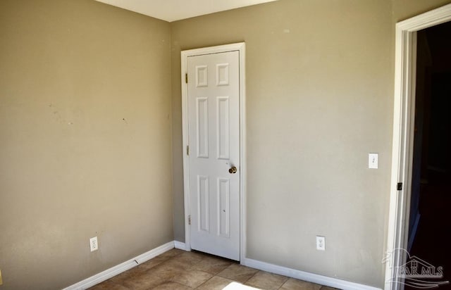 unfurnished bedroom with light tile patterned floors